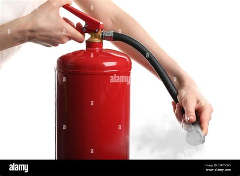 Woman Using Fire Extinguisher On White Background Closeup Stock Photo