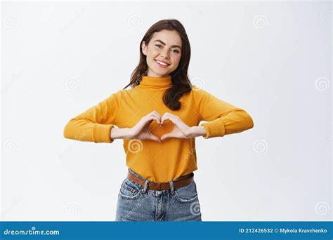 Smiling Cute Woman Showing Heart Sign I Love You Gesture Staring At Camera With Happy Face