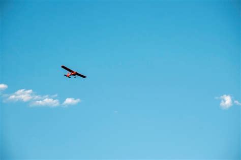 Premium Photo | Red plane flying on a blue sky