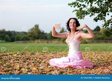 Fine Emotional Brunette Sitting On Autumn Leaves And Grass Copy Space