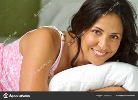 Mature Hispanic Woman Lying In A Bed Stock Photo By Pixelheadphoto 172942344