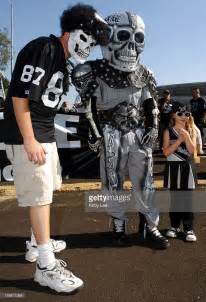 Young Oakland Raider Fans In Costumes Pose During Tailgating