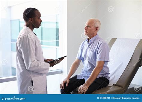 Doctor Meeting With Mature Male Patient In Exam Room Stock Image Image Of American Exam
