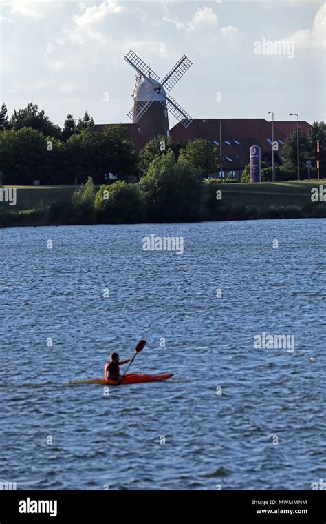 Kayaker on Caldecotte Lake, Milton Keynes, UK, with the Caldecotte Arms ...