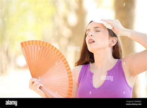 Stressed Woman Drying Sweat With A Tissue And Fanning A Hot Summer Day Stock Photo Alamy