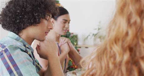 Happy Group Of Diverse Friends Sitting At Table And Eating Dinner