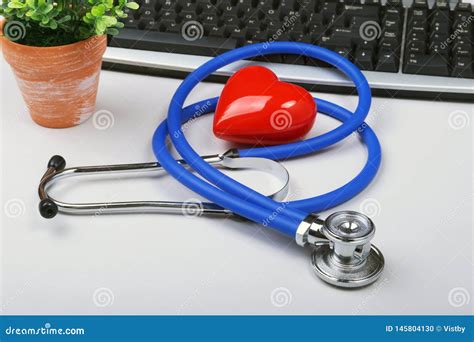 Stethoscope On Modern Laptop Computer Red Heart On White Table With