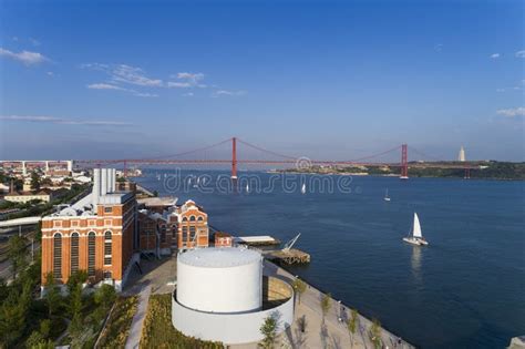 Aerial View Of The City Of Lisbon With Sail Boats On The Tagus River