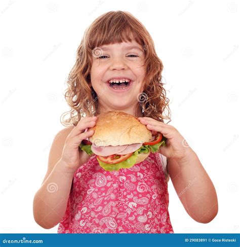 La Petite Fille Mangent Le Grand Sandwich Sur Le Blanc Image Stock