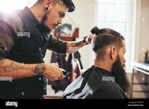 Stylish Hairdresser Cutting Hair Of Client At Barber Shop Beard Man