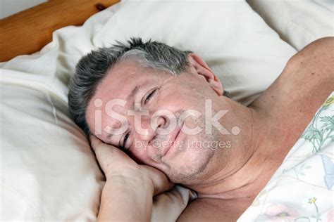 Mature Man Half Asleep In Bed Stock Photo Royalty Free Images FreeImages