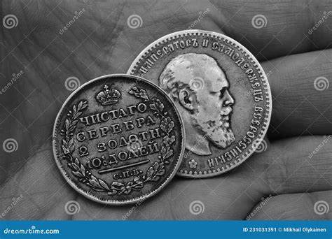 Two Old Russian Silver Coins of the 19th Century in the Palm, Black and ...