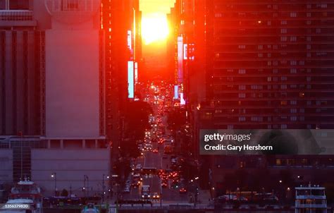 The sun rises above 42nd Street during a sunrise Manhattanhenge also ...