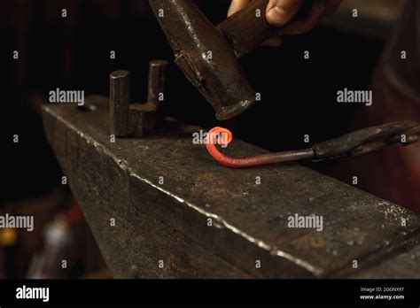 Close Up Hands Of Male Blacksmith Forge An Iron Product In A Blacksmith Hammer Red Hot Metal