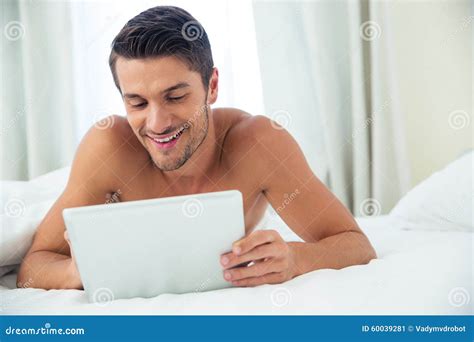 Smiling Nude Man Using Tablet Computer Stock Image Image Of Indoors Bedroom