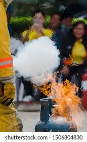 Man Using Fire Extinguisher Fighting Fire Stock Photo