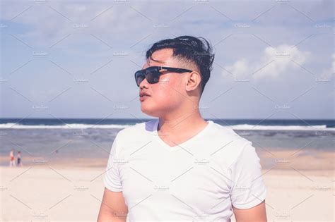 Young Asian Indonesian Man On The Beach Of Tropical Bali Island