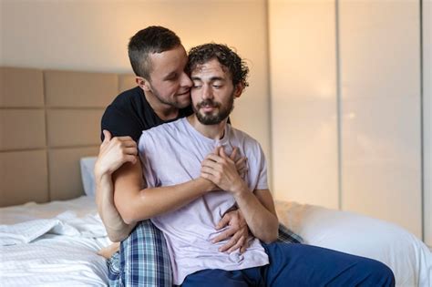 Premium Photo Happy Gay Couple Lying Down On The Bed At Home Hugging