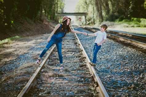 Woman In Blue Denim Dungarees And Black Tank Top Holding Hands With A ...