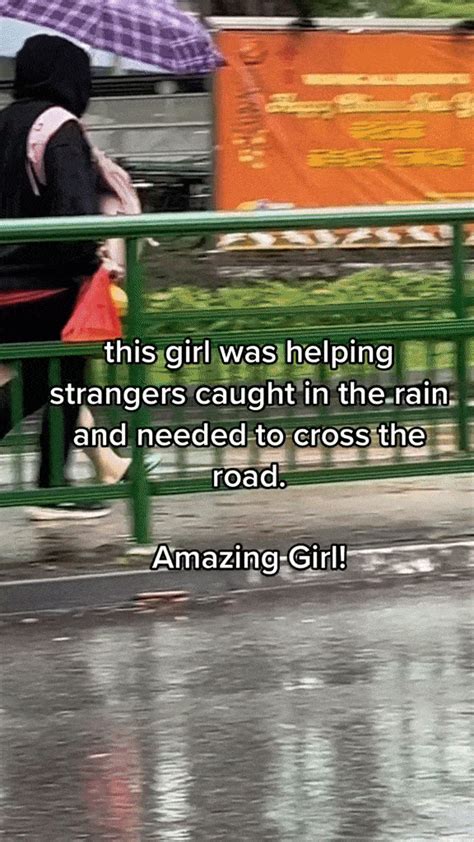 Girl With Umbrella In Boon Lay Shelters Pedestrians Across The Road To