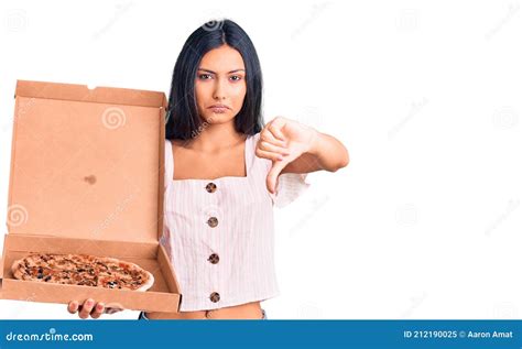 Young Beautiful Latin Girl Holding Delivery Pizza Box With Angry Face Negative Sign Showing