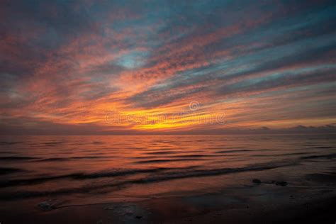 Dramatic High Contrast Clouds In Sunset Over Seaside Beach Stock Image