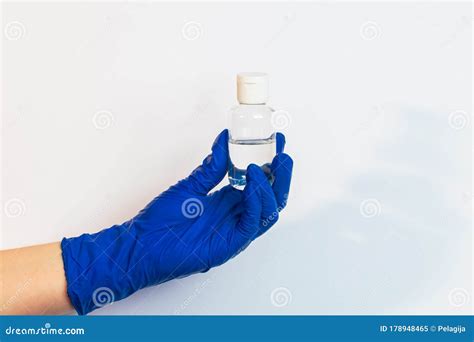 A Hand In A Blue Latex Glove Holds A Disinfectant The Concept Of