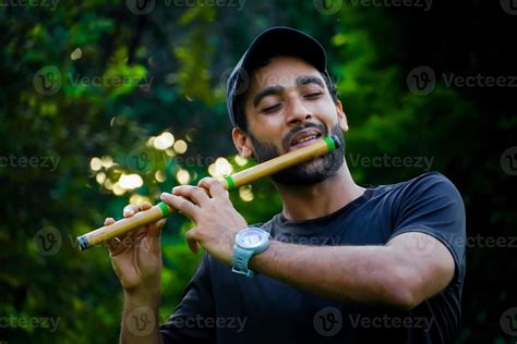 man playing flute in beautiful background 6915154 Stock Photo at Vecteezy