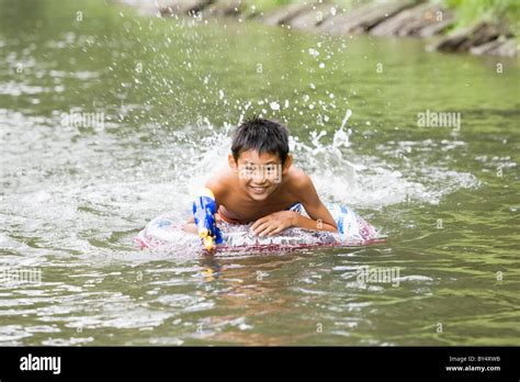 Boy Swimming River