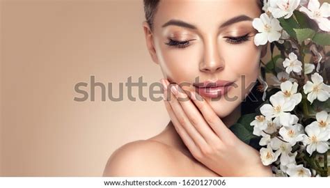 Beautiful Young Woman With Clean Fresh Skin Touching Her Face In