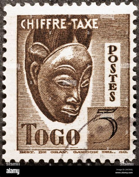 Wooden African Mask On Postage Stamp Of Togo Stock Photo Alamy