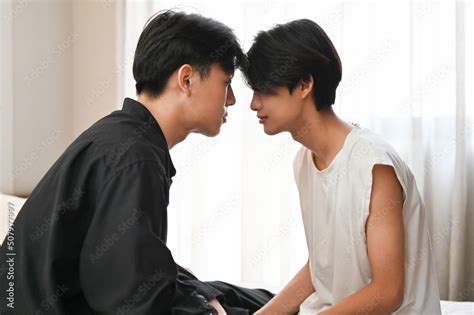 Two handsome young Asian gay men face to face showing some affection of LGBT Stock 写真 Adobe