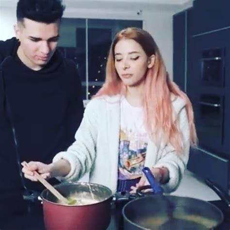 A Man And Woman Cooking In The Kitchen