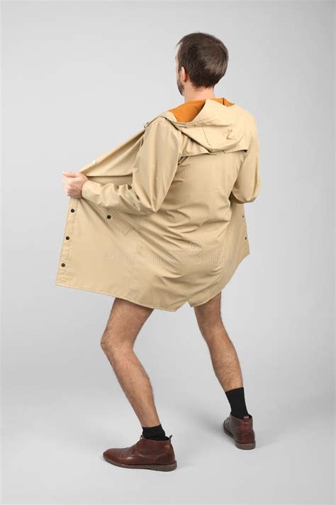 Exhibitionist Exposing Naked Body Under Coat On Light Background Back View Stock Photo Image