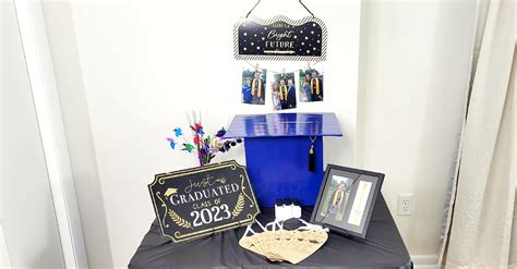 Table with big graduation card box, graduation frames, wall hanging ...