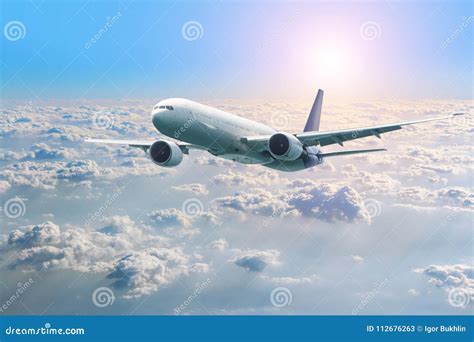 Passenger Airplane Flying Above Clouds View From The Window Plane To Amazing Sky At The Sunset