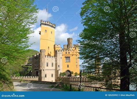 Yellow Castle With A Tall Tower That Is Reflected In The Moat Royalty ...