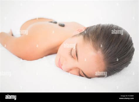 Beautiful Brunette Enjoying A Hot Stone Massage Stock Photo Alamy