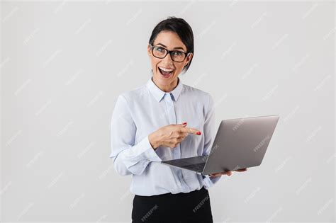 Premium Photo Portrait Of Successful Businesswoman Wearing Eyeglasses Holding Silver Laptop In