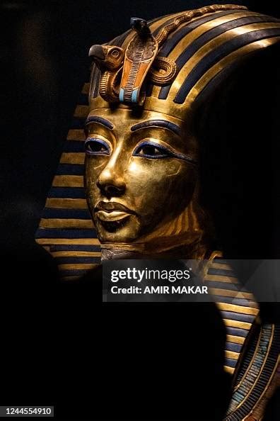 Visitors view the gold burial mask of the ancient Egyptian New... News ...