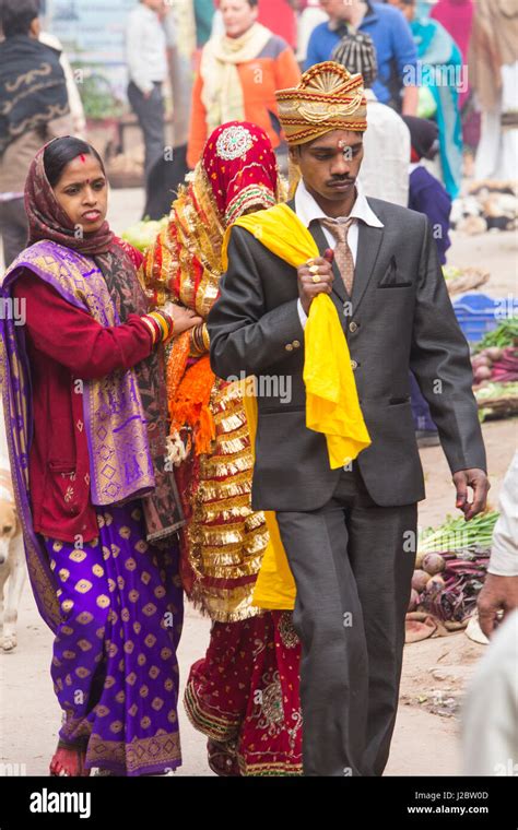 India, Uttar Pradesh, Varanasi. Wedding party walks through the streets ...