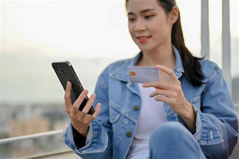 Premium Photo Beautiful Asian Woman Holding A Smartphone And A Credit