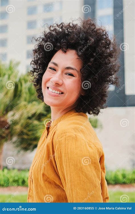 Vertical Individual Portrait Of Hispanic Young Adult Woman With Curly