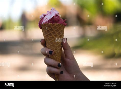 Woman S Hands Holding Melting Ice Cream Waffle Cone In Hands On Summer