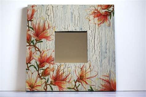 A White Frame With Red Flowers Painted On It And A Mirror In The Middle