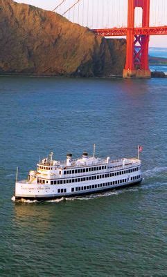 a large white boat in front of the golden gate bridge