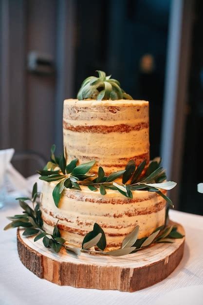 Free Photo Naked Rustic Wedding Cake Decorated With Leaves On Wooden Cake Tier