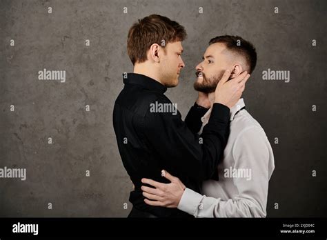 A Gay Couple In Elegant Suits Sharing An Intimate Gaze And A Tender Touch Stock Photo Alamy