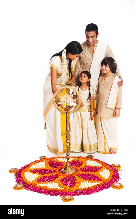 South Indian family lighting oil lamp at Onam Stock Photo - Alamy