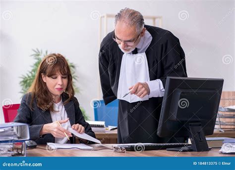 Old Male Judge And His Young Secretary In The Office Stock Image